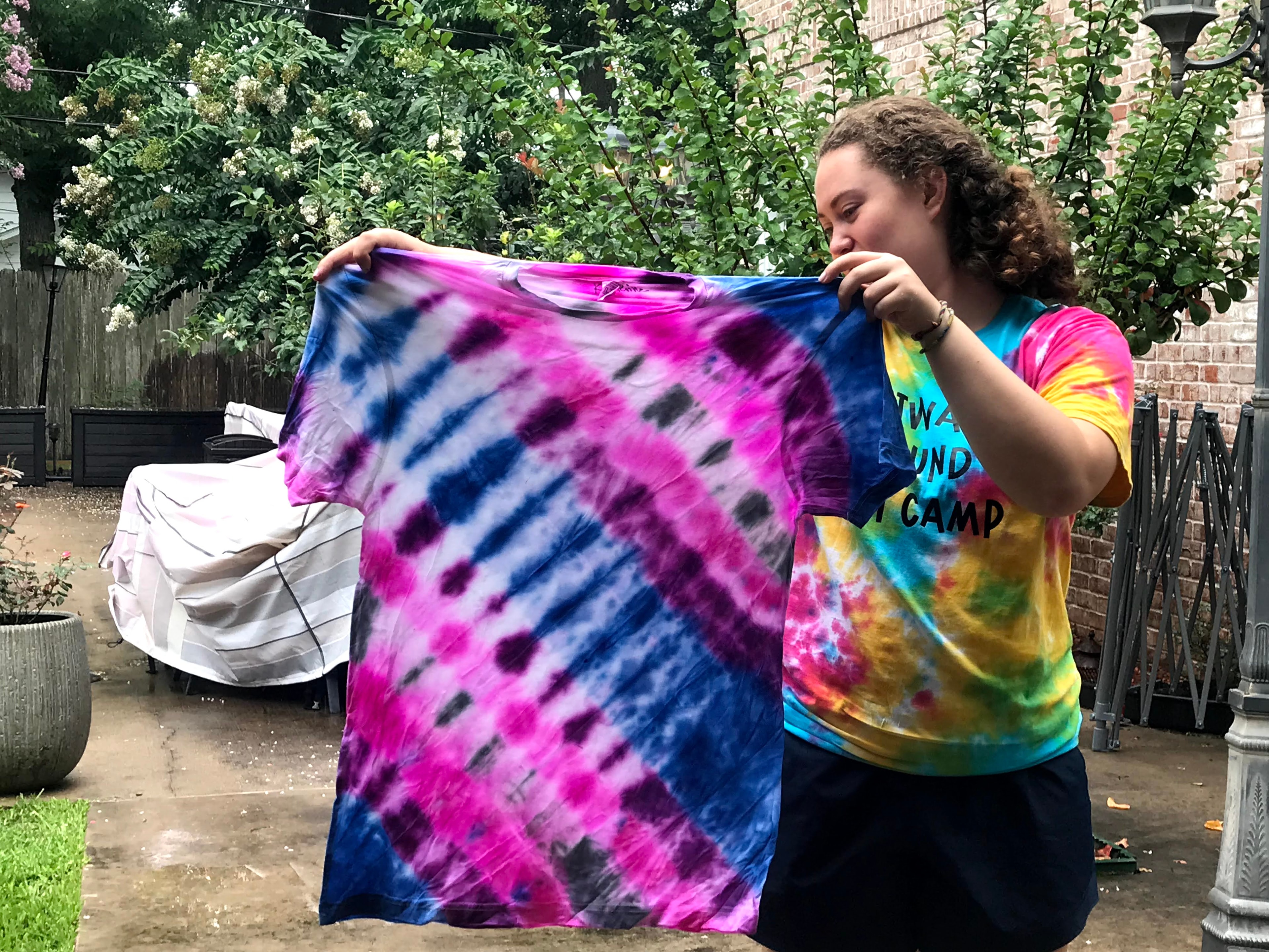 Person holding up a finished tie-dye shirt