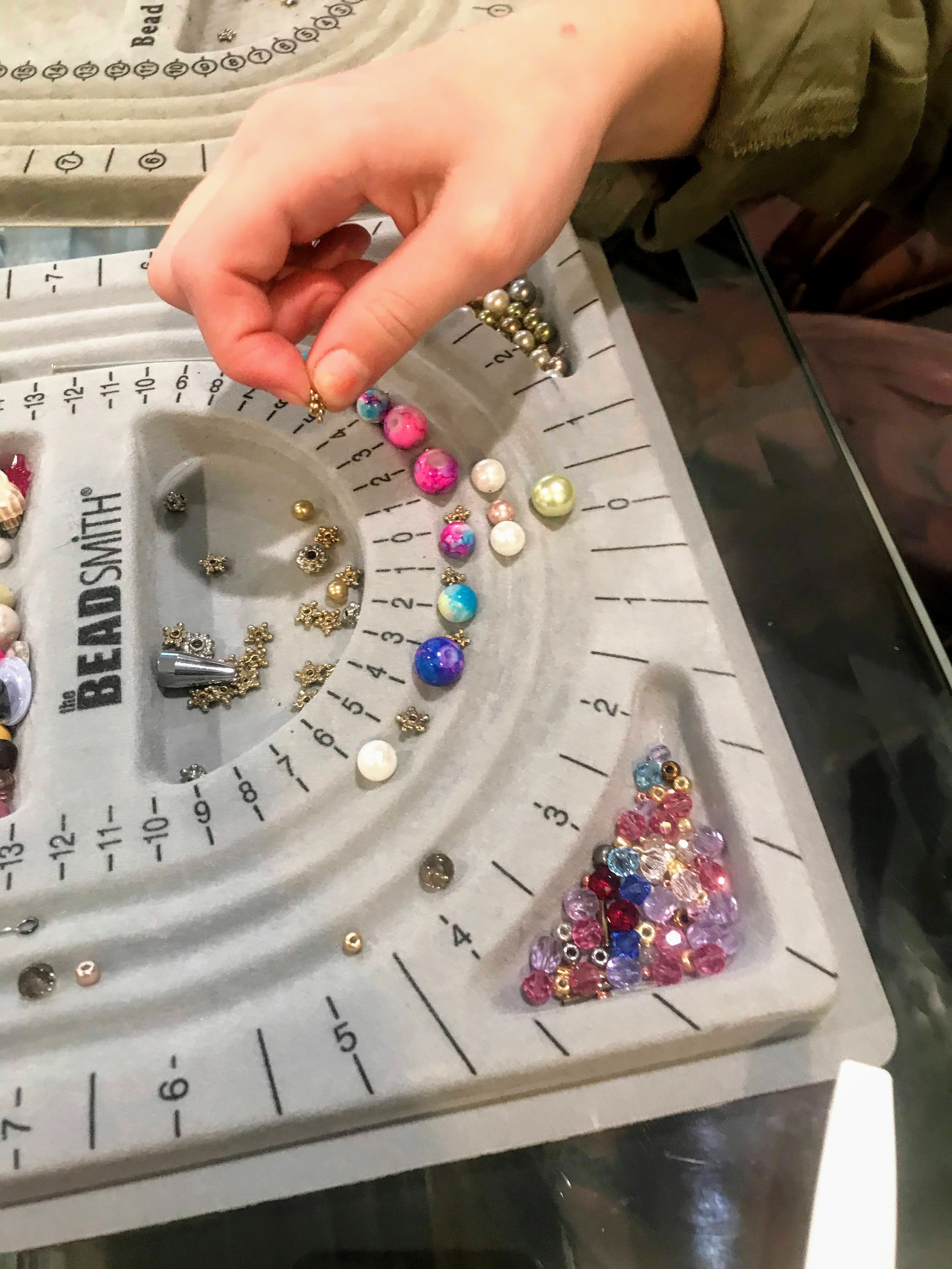 Beading tray with colorful beads and supplies